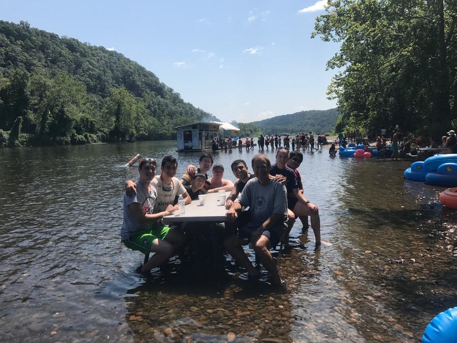 Students sitting a a table in the water