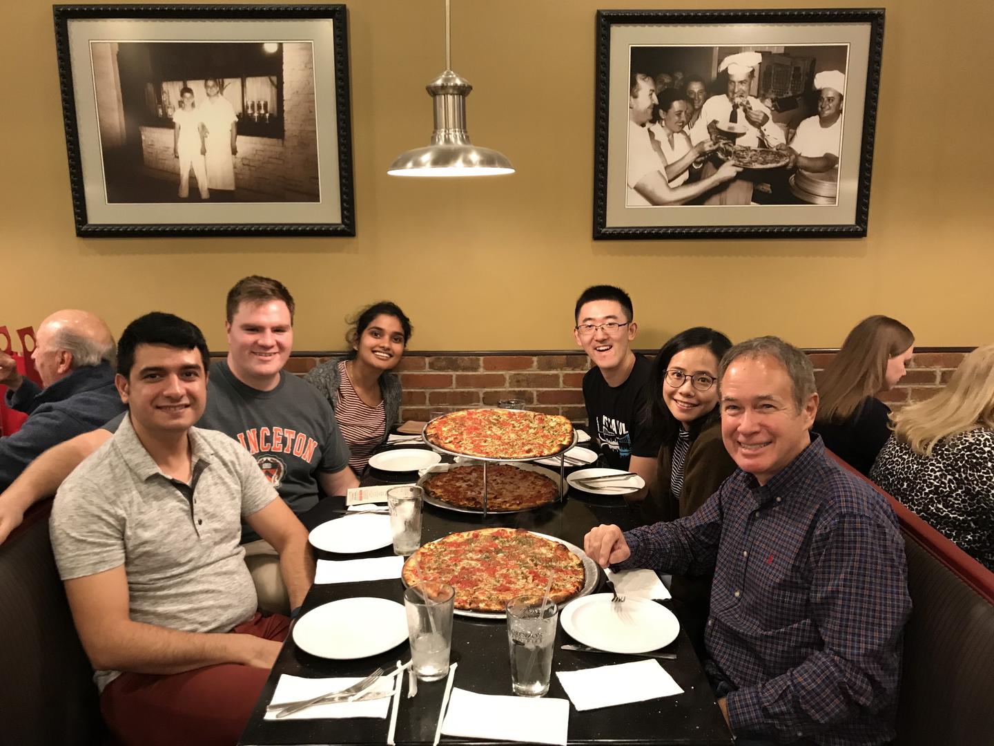 Postdocs and grads eating pizza at restaurant