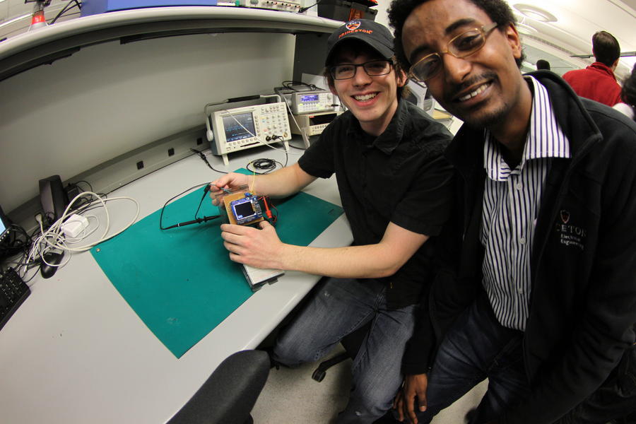 2 students in front of lab bench