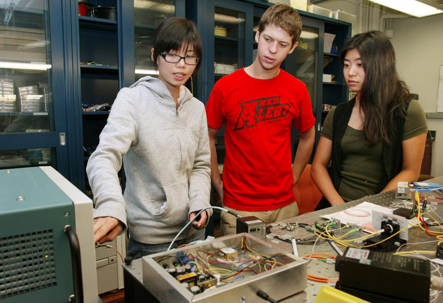 3 summer interns working on experiment
