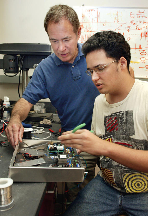 Professor Prucnal and a summer interns working on experiment