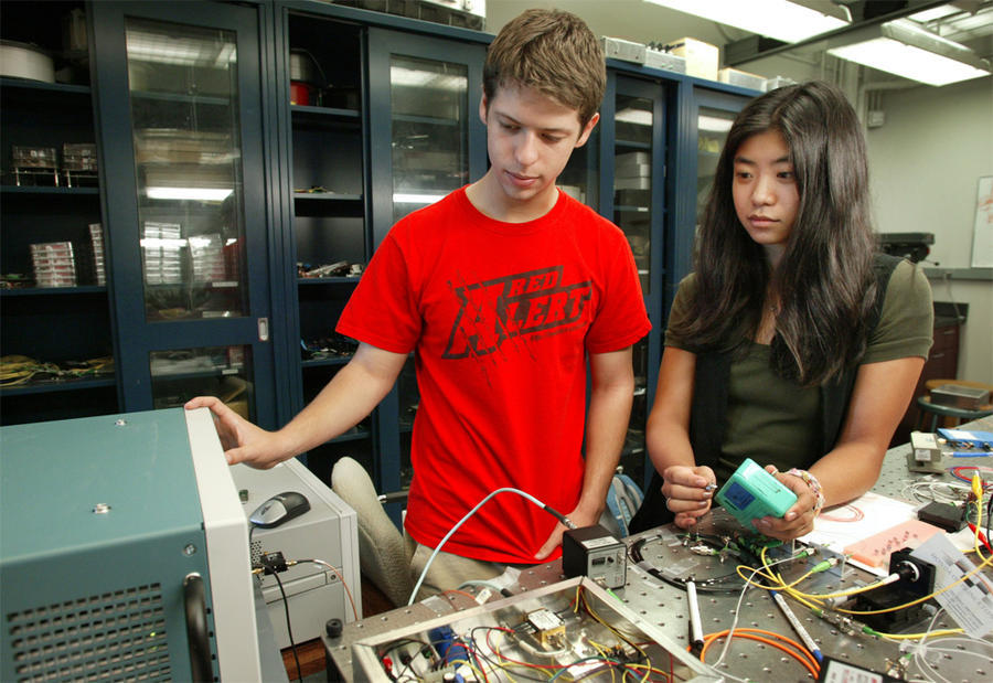 2 summer interns working on experiment