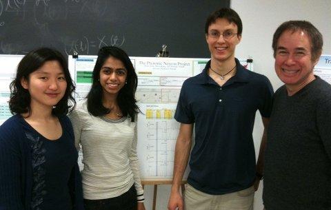 Students standing with Professor Prucnal in front of presentations